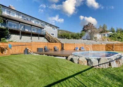 Rear of the house with wrap-around deck and pool at MacKenzie House, Peachland BC