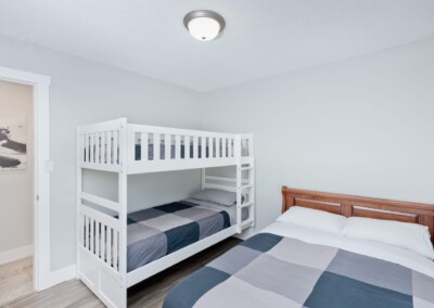 Bunk room with bunk beds and a double bed, sleeps the kids at MacKenzie House Peachland