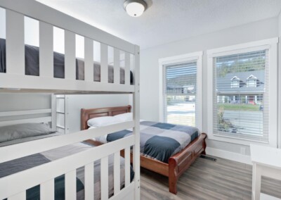 Bunk beds beside a window with lake views at MacKenzie House, Peachland BC