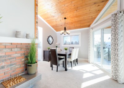Dining area with sliding door to the deck at MacKenzie House, Peachland BC