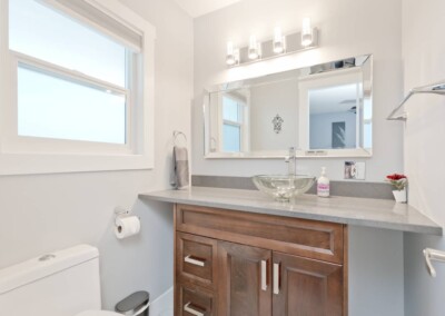 Second full bathroom with wood vanity at MacKenzie House, Peachland BC