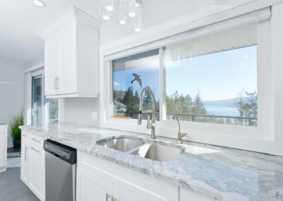 Kitchen sink beneath a window looking out over Okanagan Lake, MacKenzie House Peachland