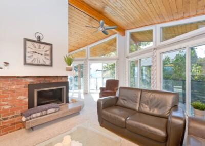 Brick fireplace and leather seating in the living room at MacKenzie House, Peachland BC