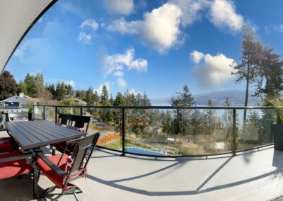 Shaded outdoor dining on the wrap-around deck at MacKenzie House, Peachland BC